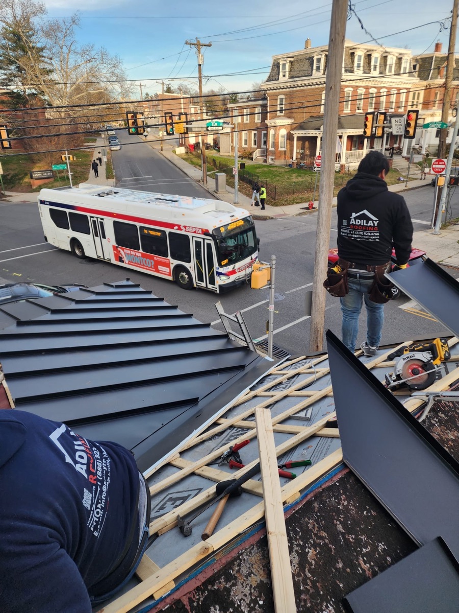 Adilay Roofing crew installing a standing seam metal roof on a Philadelphia home